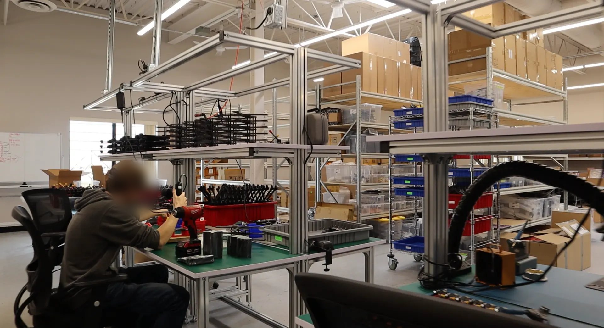 AirMetal Robotics technician assembling airframe components at a workbench in the Kanata, Ontario facility