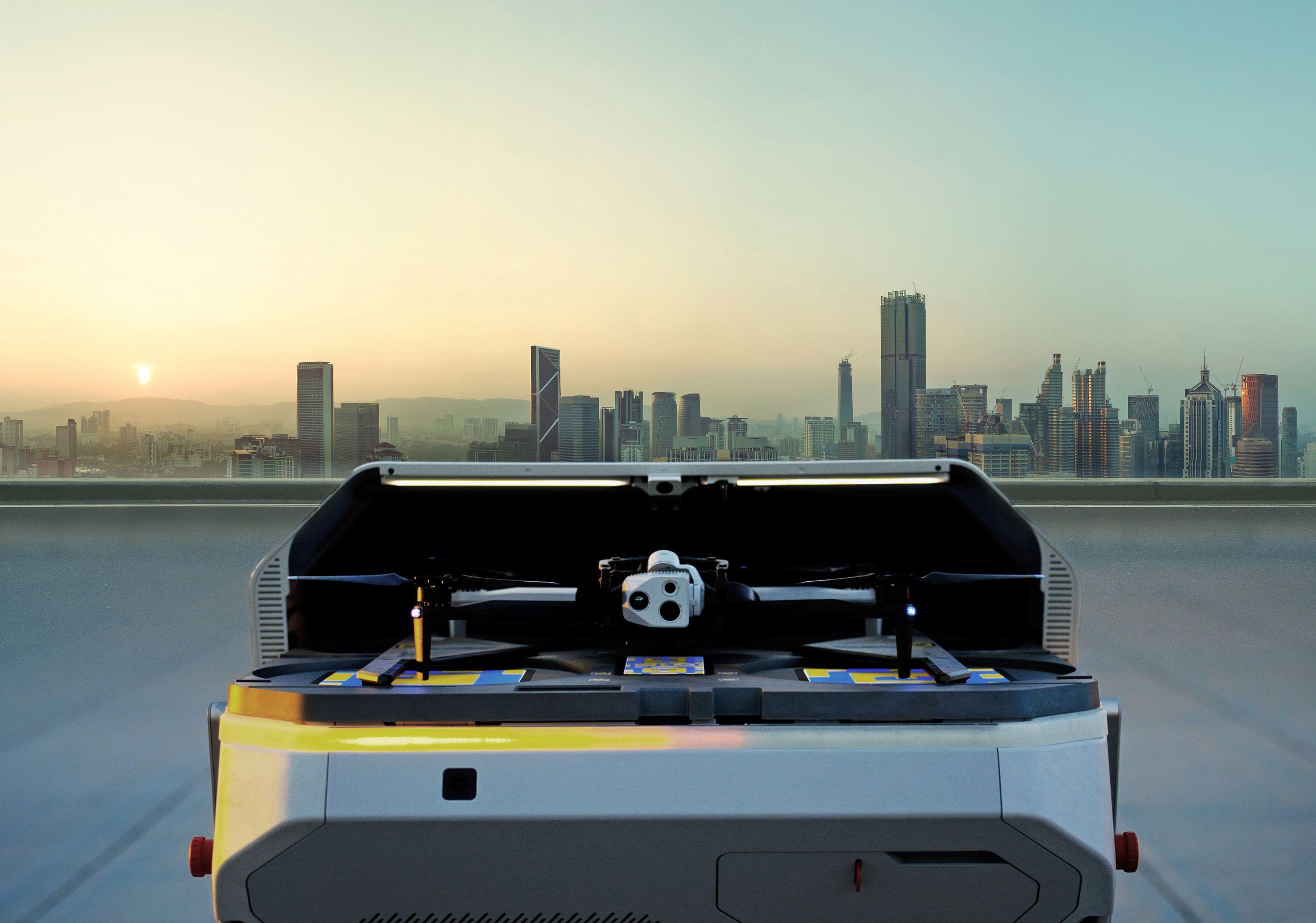 Skydio Dock for X10 with its roof open and X10 aircraft inside, against a city skyline.
