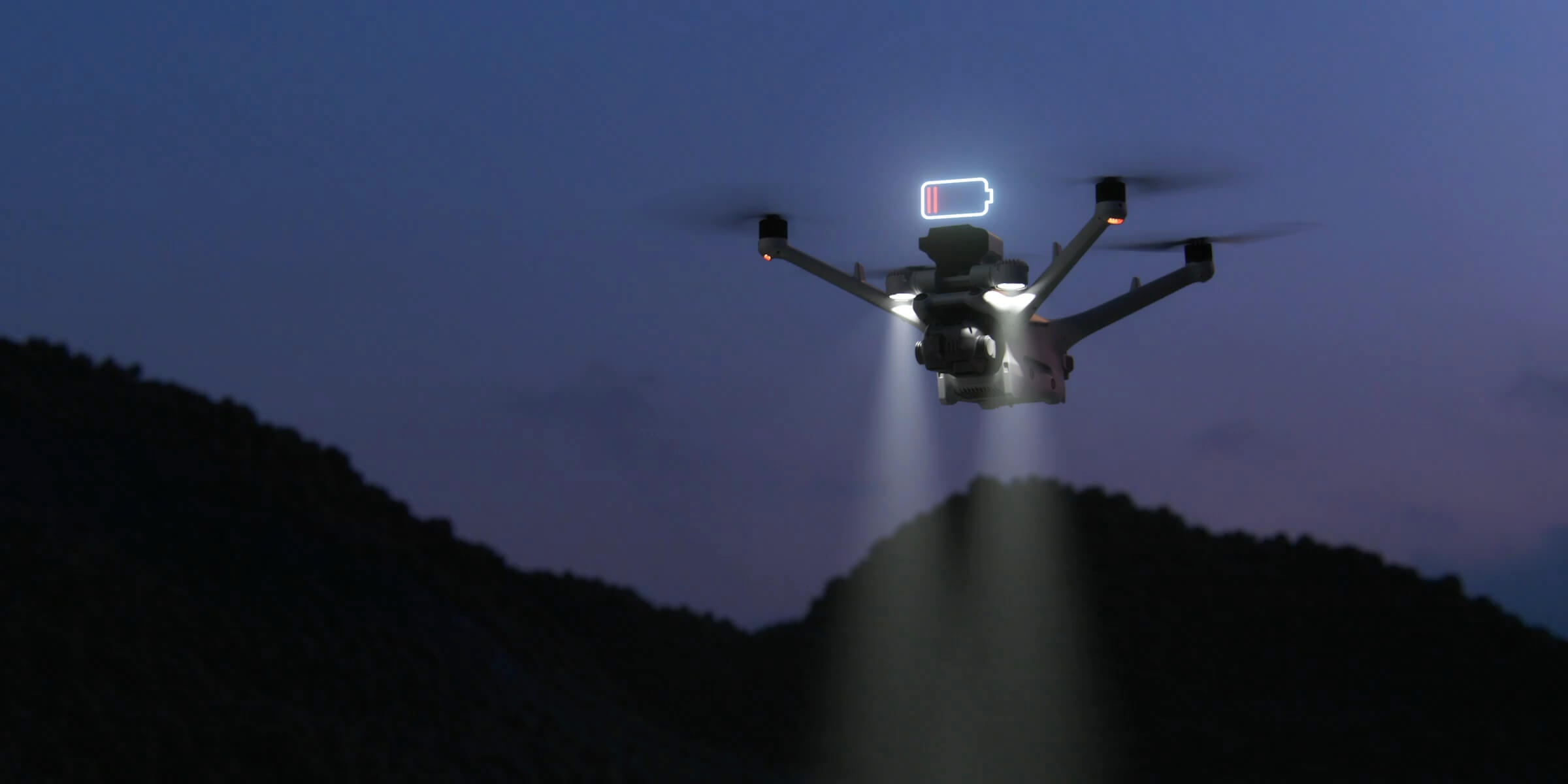 DJI dock drone flying at dusk with its lights on and a low-battery indicator shown.
