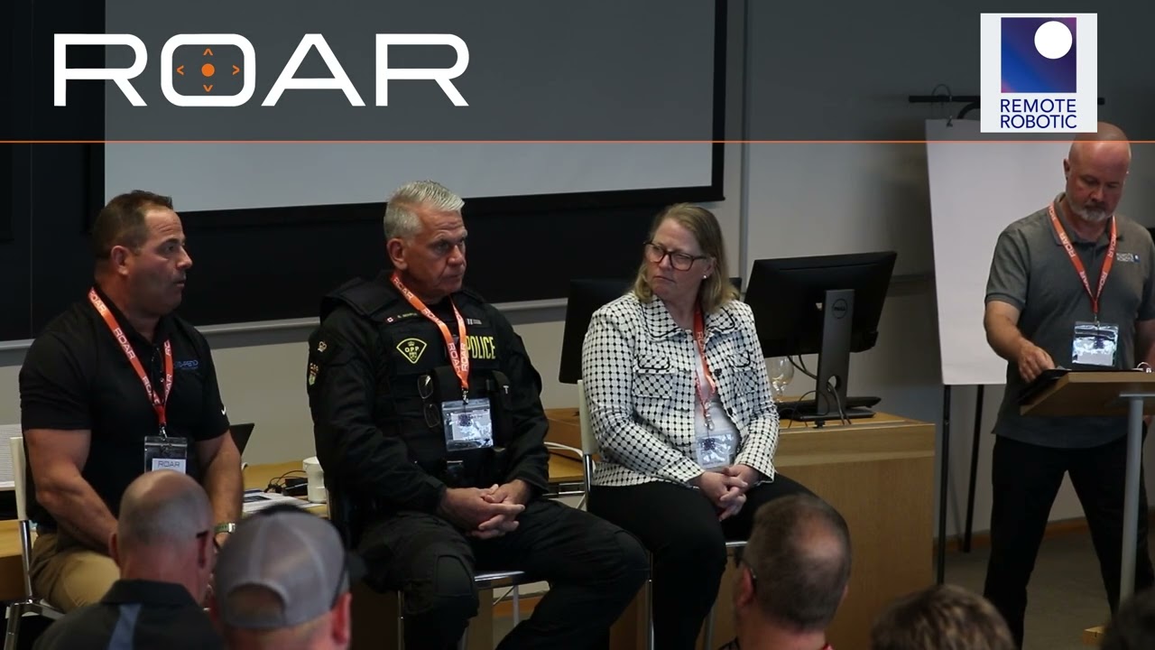 Screen grab from the ROAR public safety and counter-UAS panel video, showing the panelists on stage.