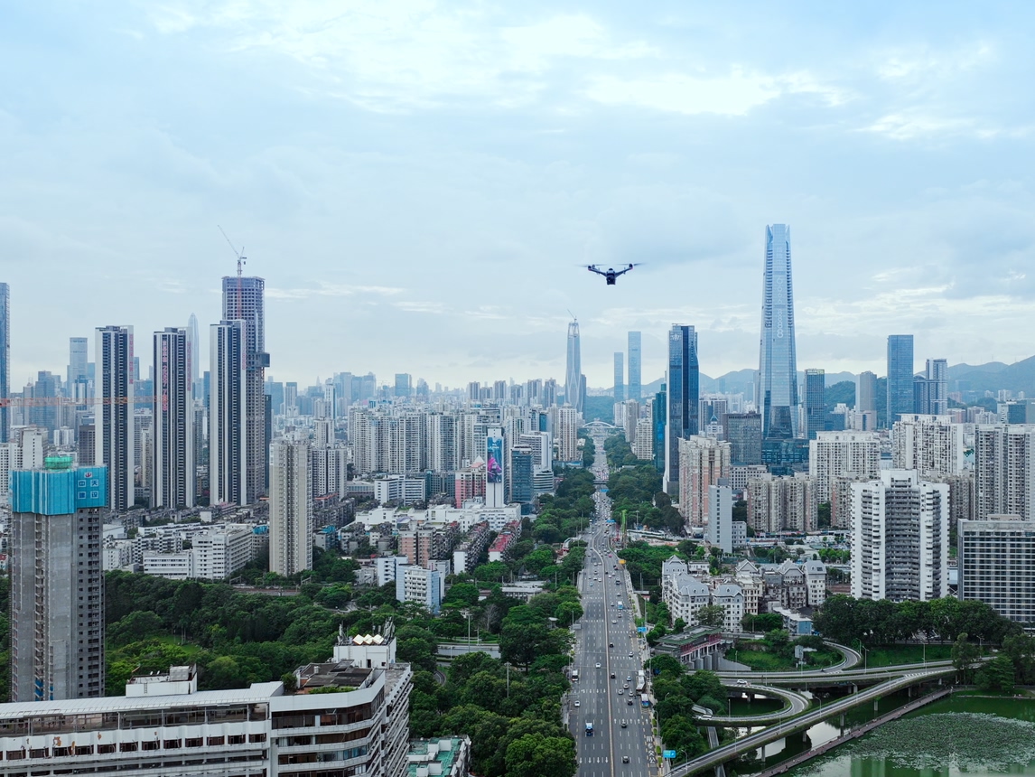 DJI enterprise drone flying over a city on patrol, from official DJI Dock 4 imagery.