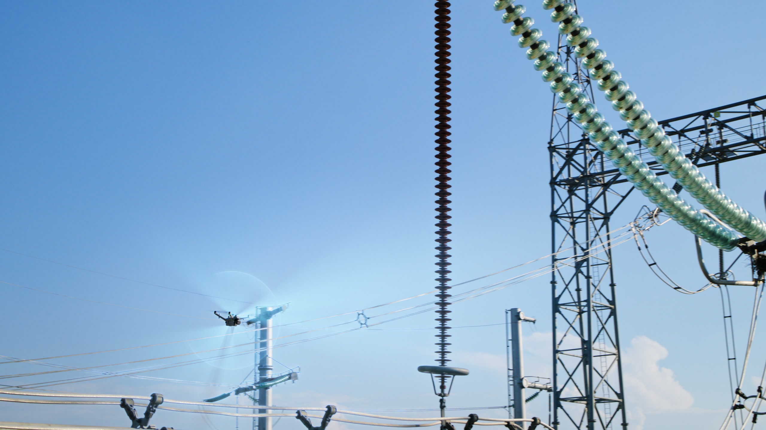 DJI Matrice 5TD flying at a safe distance from high-voltage substation structures, from official DJI imagery.