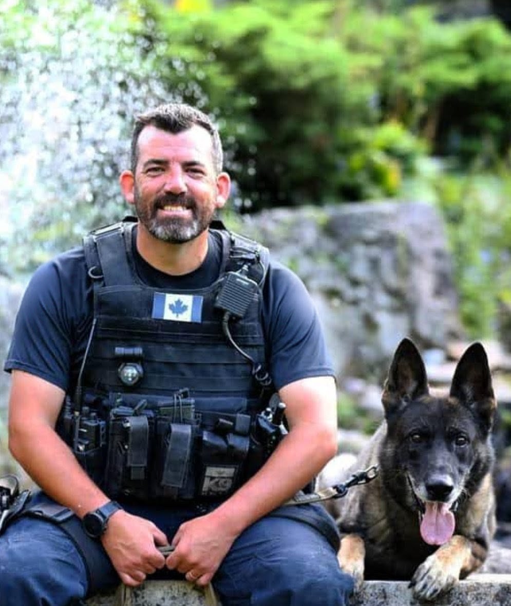 Jeffrey Burns in tactical kit with his police K9 partner