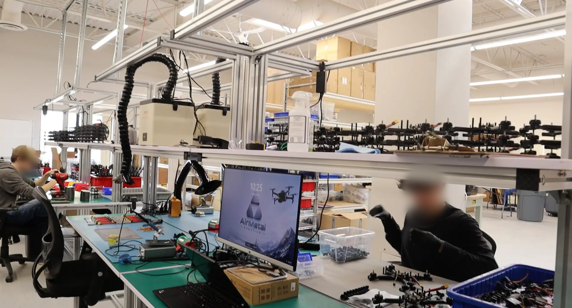 Technicians assembling unmanned aircraft and tactical mesh radio modules on a Canadian production floor
