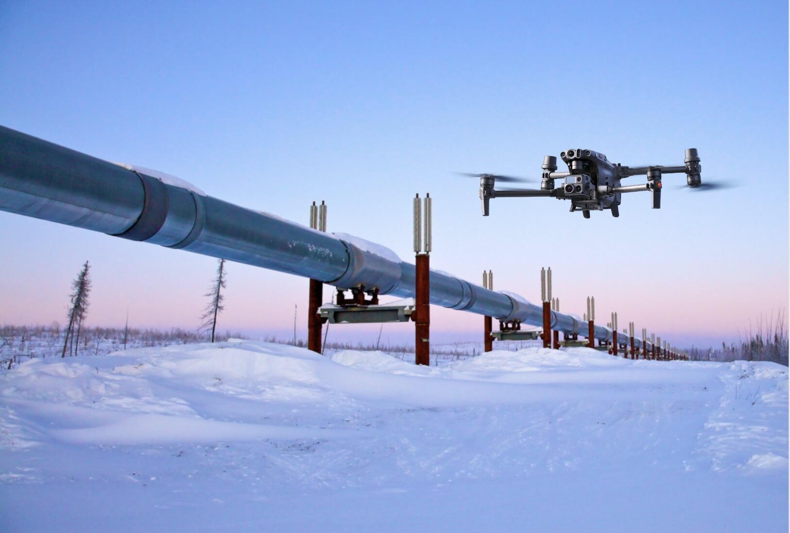 DJI enterprise drone inspecting an above-ground pipeline through a snow-covered oil and gas corridor.