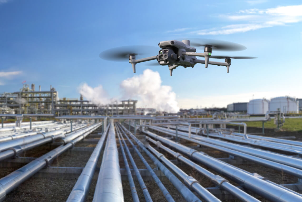 DJI Matrice 4T inspecting pipework at an oil and gas processing facility.