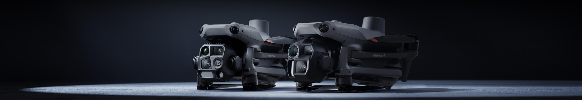 DJI Matrice 4 Series aircraft — studio product shot of two M4 airframes with multi-sensor gimbals.